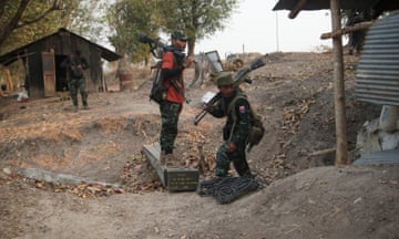 Members of the Karen National Liberation Army and the People’s Defence Force collect weapons after they captured an army outpost in the southern part of Myawaddy township in Myanmar on 11 March