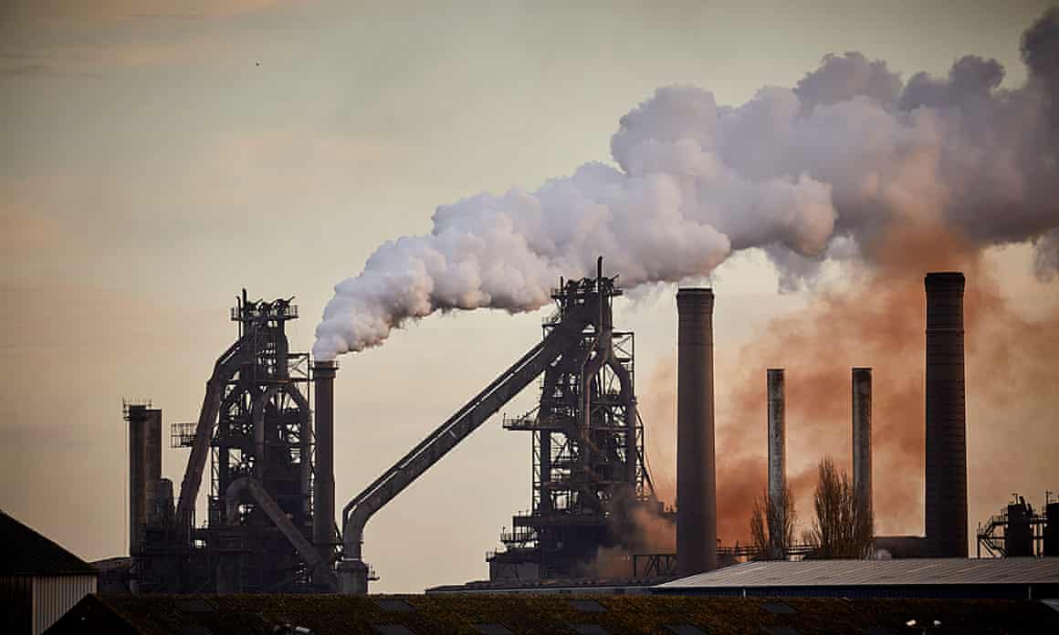 Steam or smoke rises from chimneys