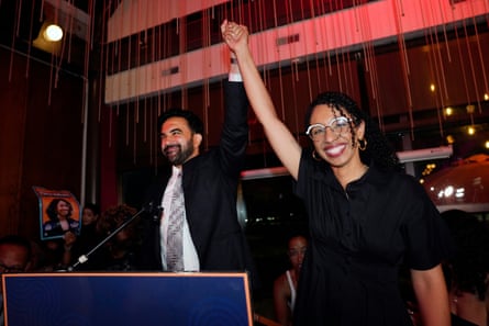 a man and a woman hold up their hands together