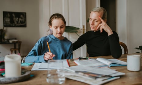 A mother helping her daughter with her homework