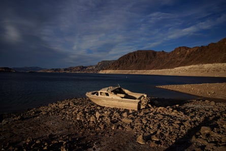 a boat sits on a rocky shore