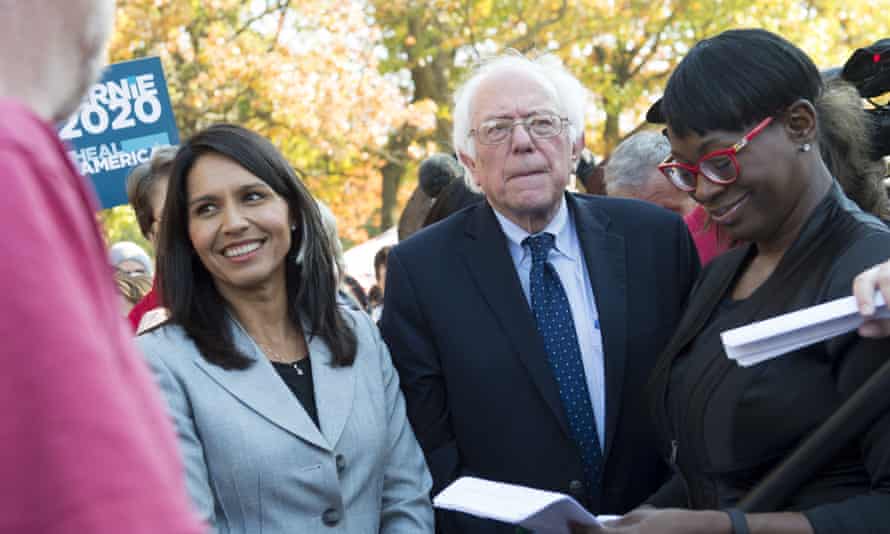 Bernie Sanders waits alongside Gabbard to speak during a rally to stop the Trans-Pacific Partnership in Washington DC, 17 November 2016.