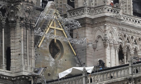 Workers install tarpaulins at Notre Dame Cathedral