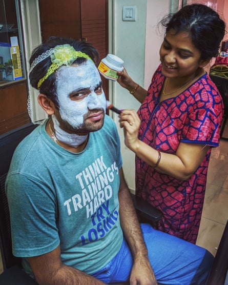 Sneha applies a face mask for her partner, Sourabh.