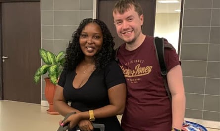 A couple photographed together at an airport