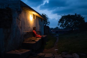Suman, rests outside her family home after a long day of work, classes and dance rehearsals.