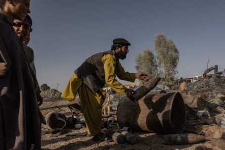 People cleaning up debris in Sangin, Helmand