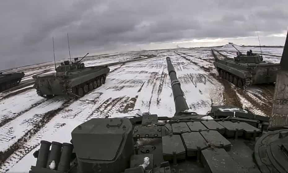 In this image from video released by the Russian Defense Ministry Press Service on Wednesday, Feb. 2, 2022, Russian and Belarusian armored vehicles drive during a joint military drills at Brestsky firing range, Belarus. 
