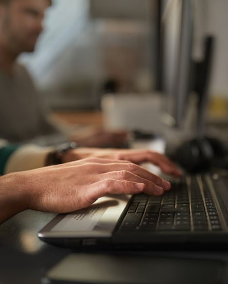 Close up of a businessman using laptop in the office.