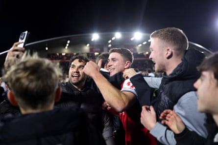 Fans celebrate with the Fleetwood player Harrison Neal.