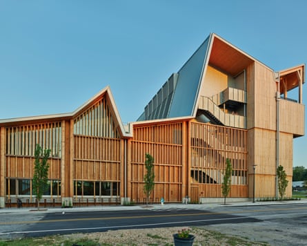 A large, modern-looking wooden building, with beige- and orange-coloured wood