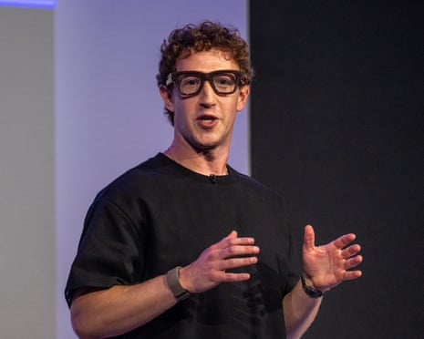 Mark Zuckerberg, wearing Meta glasses, gestures while speaking on stage