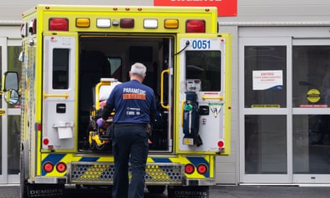 A paramedic loads his stretcher back into the ambulance after bringing a patient to the emergency room at a hospital in Montreal, Quebec, on 12 April 2022.