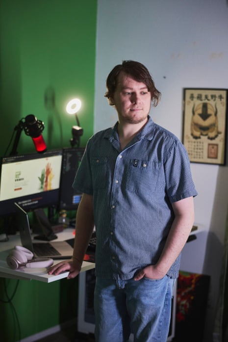 A man posing for a photo in his home.