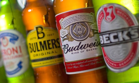 (FILES) A file picture taken in London on October 13, 2015, shows bottles of beer and cider produced by Belgian-Brazilian group Anheuser-Busch InBev, (Budweiser and Beck’s) and British brewer SABMiller (Peroni and Bulmers).