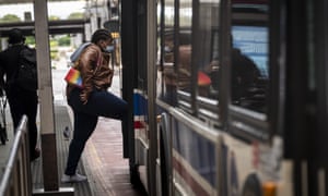 A commuter wearing a protective mask boards a Chicago Transit Authority bus in Chicago, Illinois, US, on Wednesday, 3 June 2020.