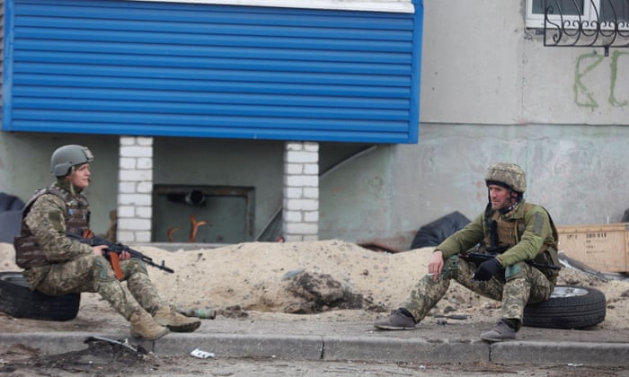 Ukrainian service members rest on a street, in Sievierodonetsk, Luhansk region