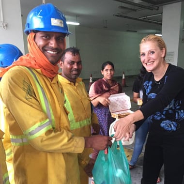 Niaz Zomorodian giving food to local construction workers at her Dubai fridge