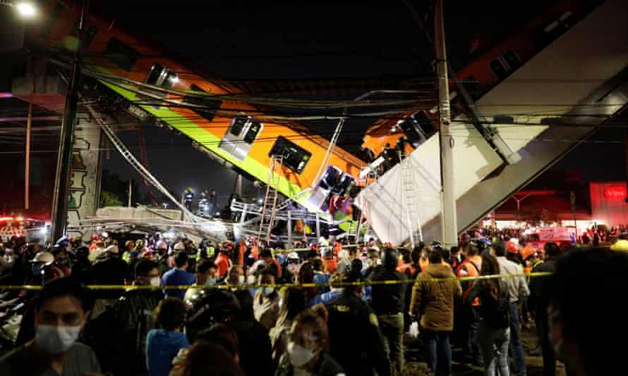 Rescuers work at a site where an overpass for a metro partially collapsed with train cars on it at Olivos station in Mexico City