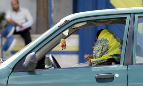 An Iranian woman driving her car in Tehran.