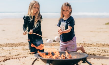 Toasting marshmallows over a firepit at Watergate Bay Hotel