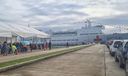 Chinese hospital ship docked on a big wharf with a cloudy sky