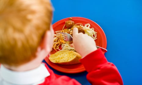 A boy eating a school dinner