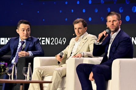 three men sit together at a conference