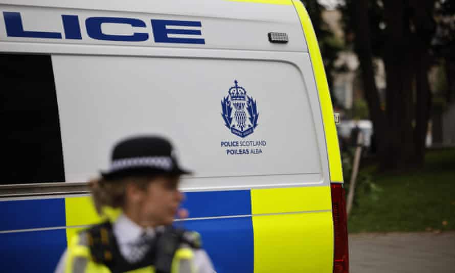 Police officer in front of a Police Scotland van