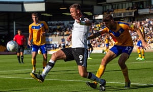 Port Vale striker Tom Pope controls the ball during a match against Mansfield.