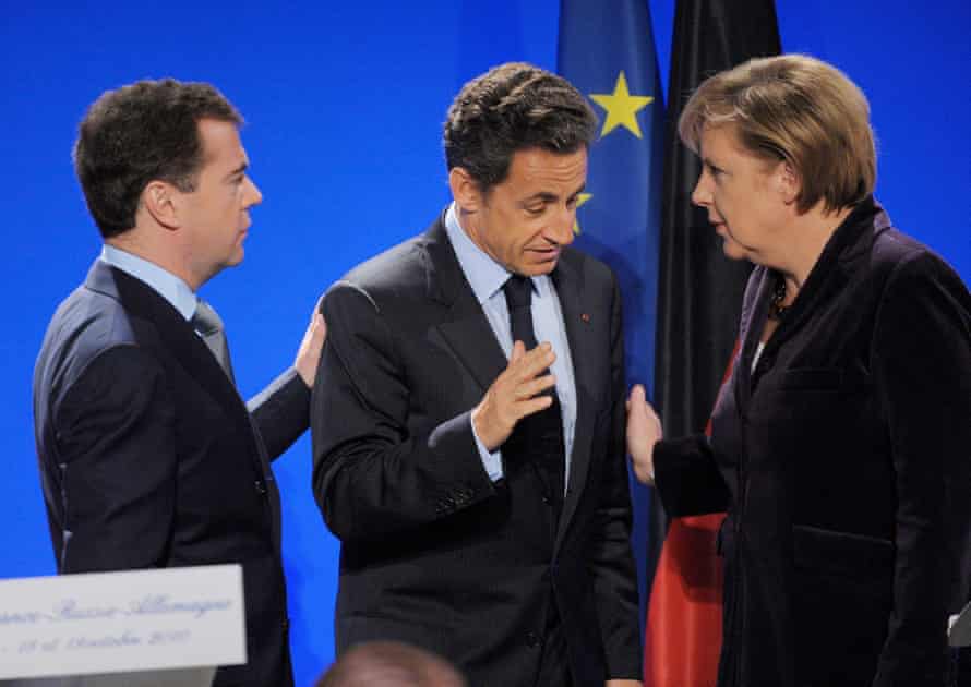 Dmitry Medvedev, Nicolas Sarkozy and Angela Merkel at the end of a press conference in Deauville, France, in October 2010.