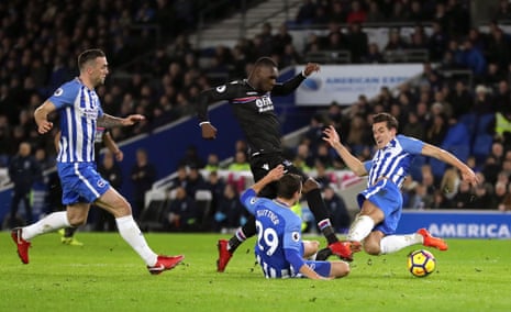 Christian Benteke is tackled by Markus Suttner and Lewis Dunk.