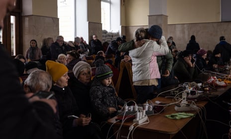 Kherson residents wait for the evening evacuation train and charge their phones at the train station, as Ukraine evacuates citizens amid fears infrastructure is too badly damaged to support people during winter. 