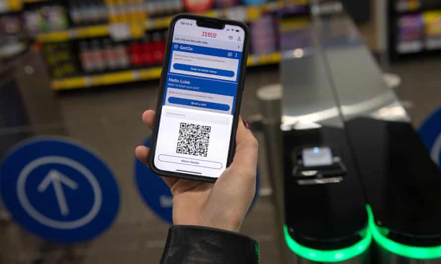 Tesco app showing QR code, at gates to GetGo store