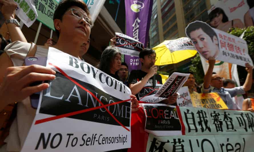 Protesters, holding up a portrait of a Denise Ho, demonstrate outside the shopping mall in Hong Kong.