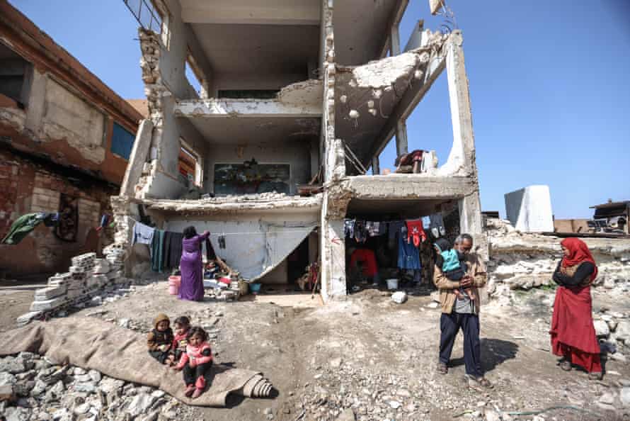 Families shelter in the ruins of a school, Idlib, Syria.