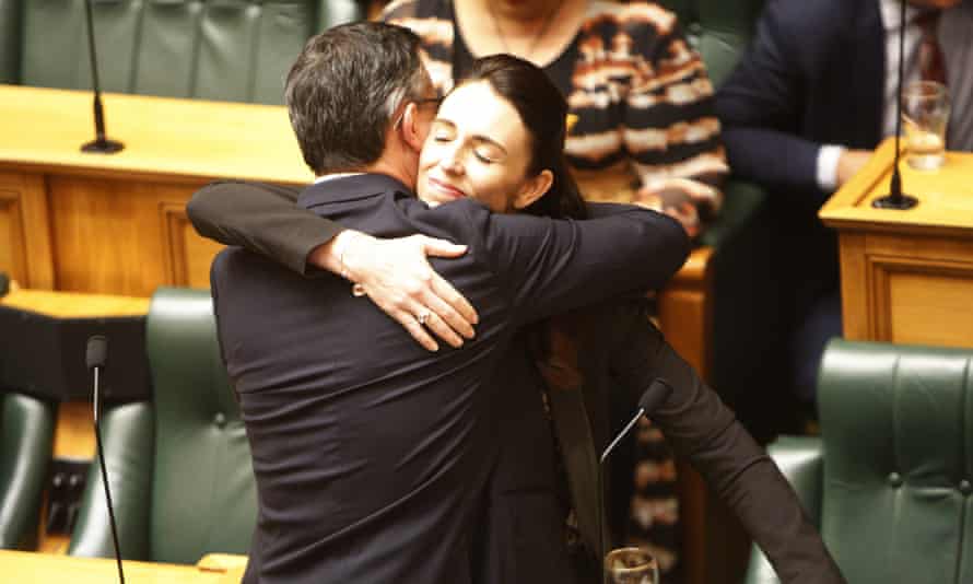 Jacinda Ardern embraces James Shaw in parliament after MPs joined forces across the aisle to pass a bill aimed at combating climate change.