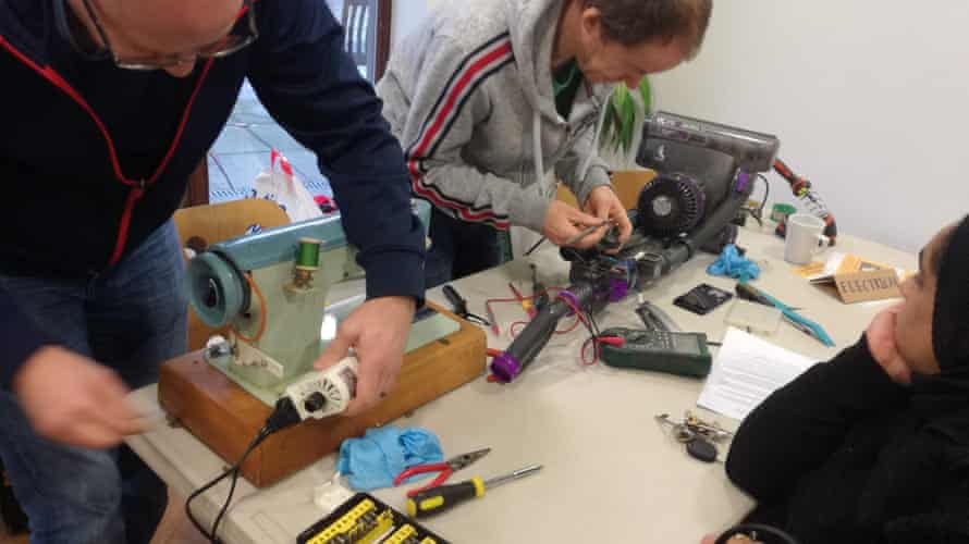 Volunteer menders get to work at Levenshulme Repair Café in Manchester.