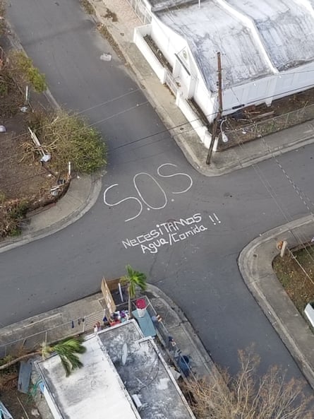 An aerial photo of an SOS sign written at a crossroads in Puerto Rico during a hurricane