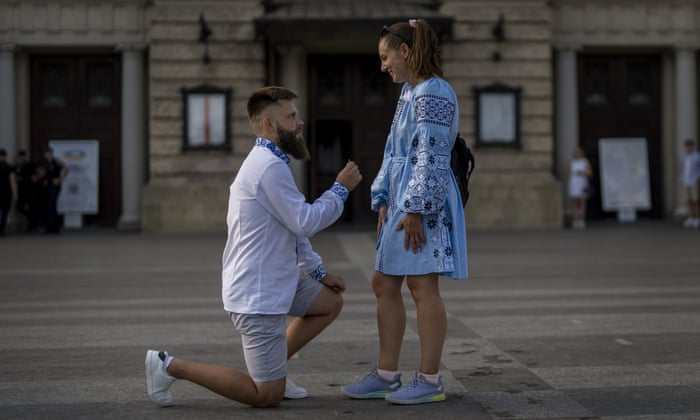Oleksandr offers an engagement ring to his girlfriend Kateryna in downtown Lviv, Ukraine. Kateryna, who just returned from Poland on Saturday, was met at Lviv train station by her fiancé Oleksandr, ending six months of separation because of the war.
