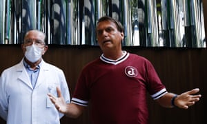 Brazilian President Jair Bolsonaro, right, and his personal doctor, Antonio Luiz Macedo, give a press conference.