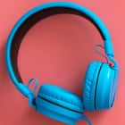 Bright blue headphones on pink background