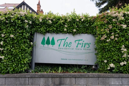 A sign for The Firs care home in green lettering