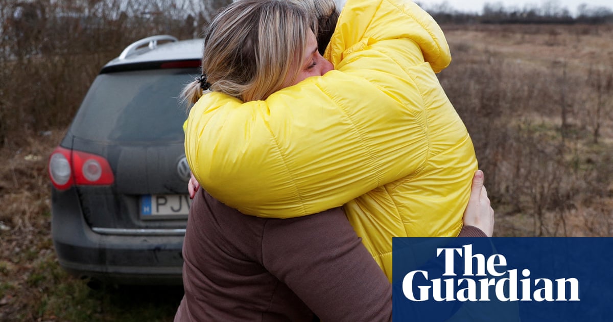 Ukrainian mother hugs her children brought to safety by a stranger – video