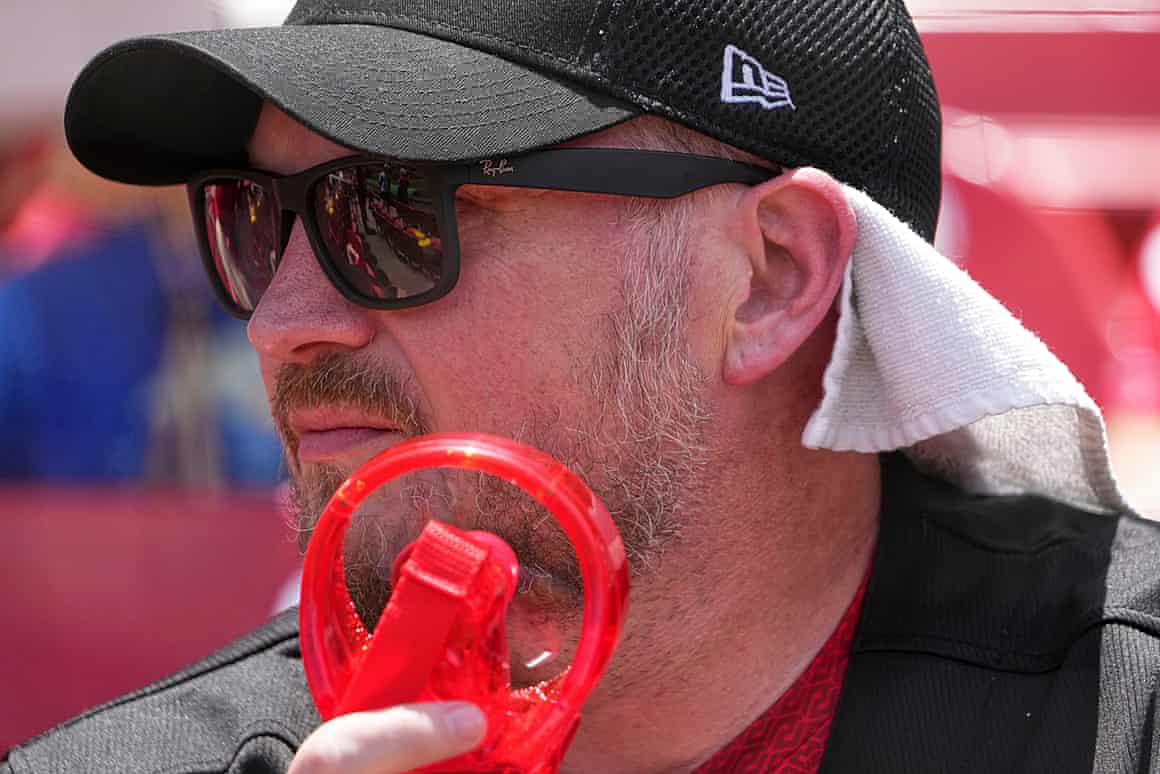 a man with a handheld fan