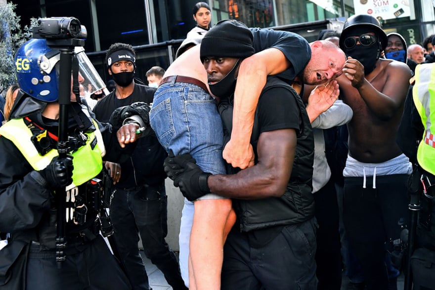 Patrick Hutchinson carries a counterprotester to safety during a Black Lives Matter protest in 2020 