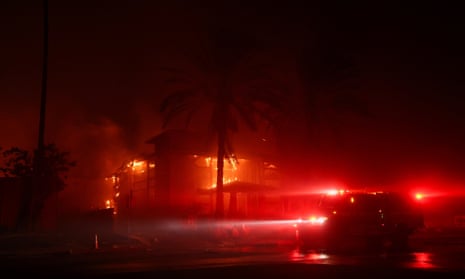 A firefighting vehicle stands in front of the Two Palms Nursing Center, which was burnt by the Eaton Fire in Pasadena.