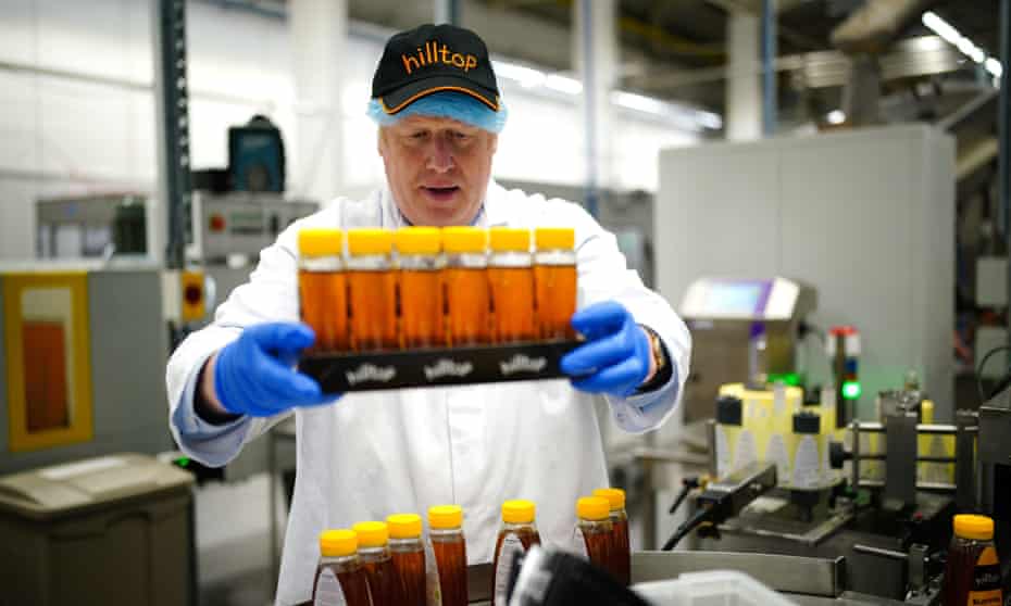 Boris Johnson wears a Hilltop cap and holds some honey containers