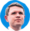 man in suit looking ahead with blue background