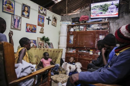 A family watches television coverage of the state funeral of Britain’s Queen Elizabeth II, at their home in the low-income Kibera neighbourhood of Nairobi, Kenya on 18 September